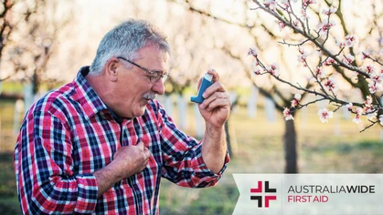 Elderly man using inhaler to relieve asthma symptoms