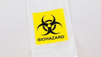 Plastic biohazard bag with logo brand and text sign.