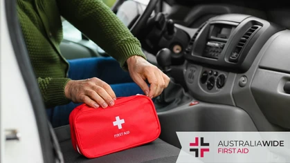 A woman unzipping a first aid kit in the front of her car