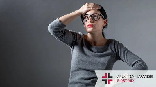 A frustrated woman holding her hand to her head